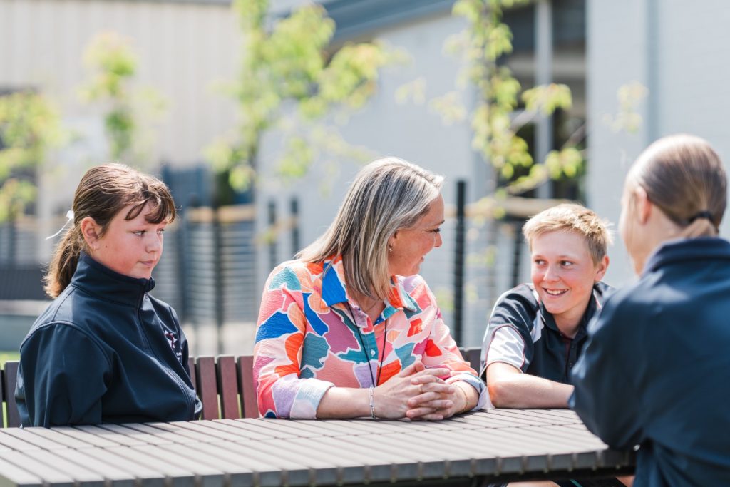 Teacher speaking with students