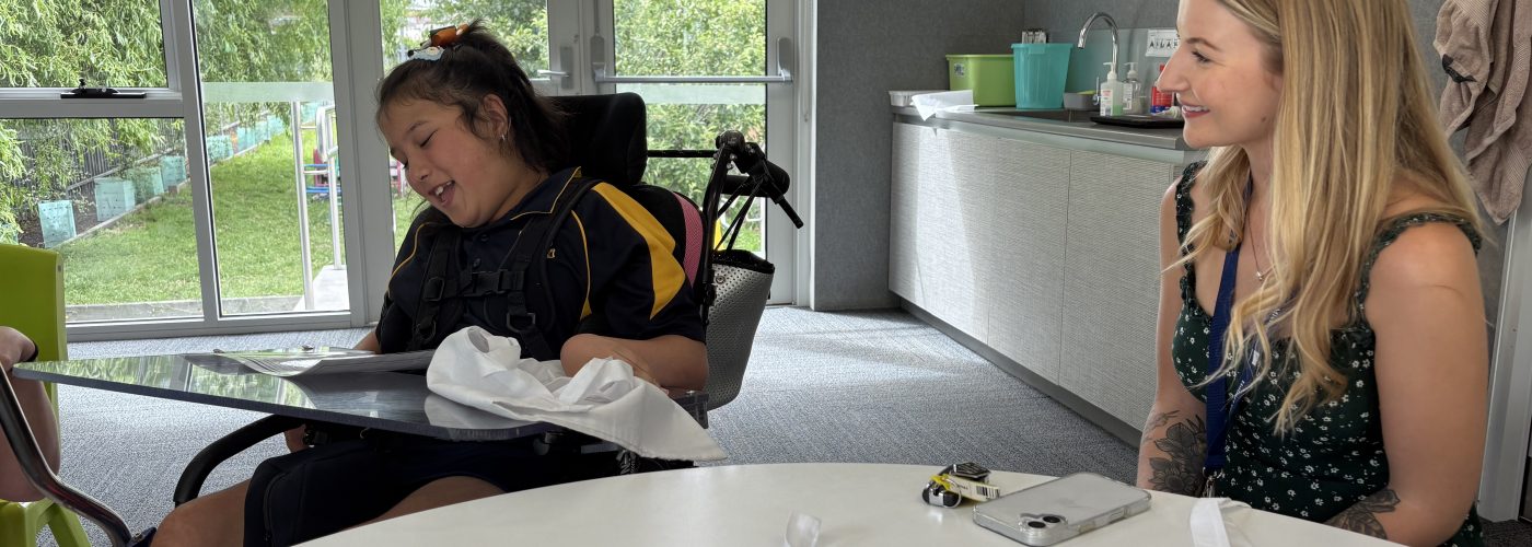 A girl in a wheelchair and a woman sitting next to her